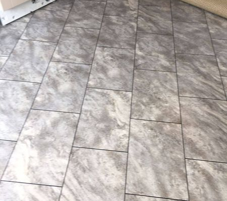 Main kitchen area with pale grey slate rectangular LVT flooring laid diagonally with grout effect design strips
