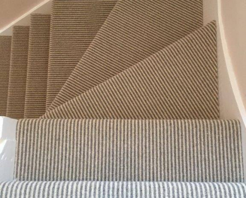 Winder staircase with wool mix loop stripe carpet viewed from top showing two straight steps and three winder steps