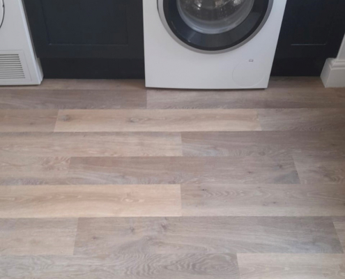 Limed washed oak LVT flooring installed in Surrey utility room with clean white walls and practical layout