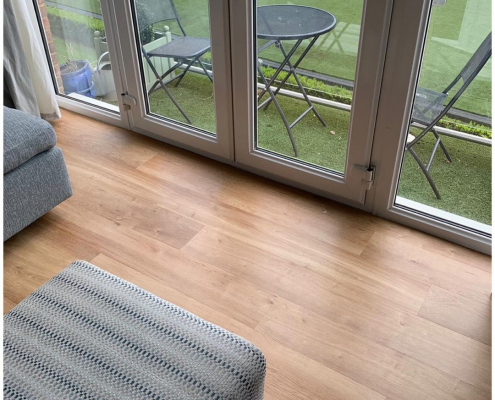 Close-up of Karndean French Oak plank LVT flooring near French doors in Surrey apartment