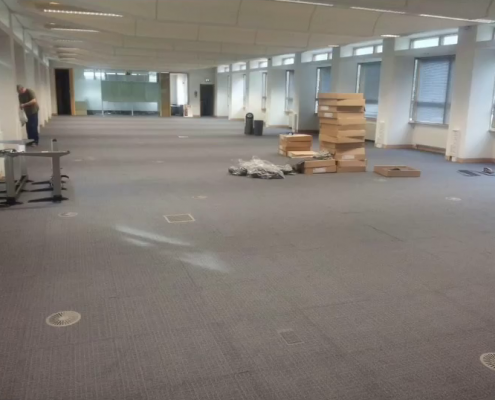 Grey carpet tile installation in office in Redhill with modular flooring being fitted