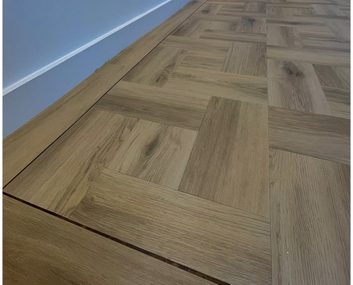 Close-up of Amtico Signature basket weave LVT flooring in Wild Walnut and Cornish Oak with tramline border