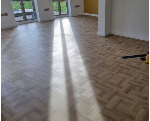 Bright Reigate living room with Amtico Signature Wild Walnut and Cornish Oak basket weave LVT flooring and garden view