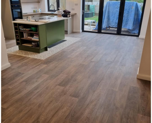 Open-plan Surrey kitchen-diner with wide plank oak LVT flooring installed