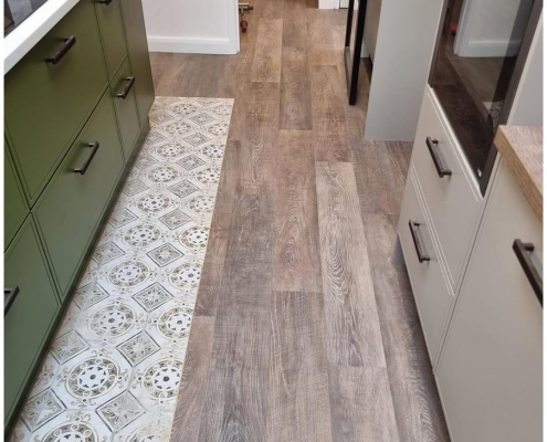 Redhill kitchen with oak LVT flooring installed, highlighting warm tones and textured finish