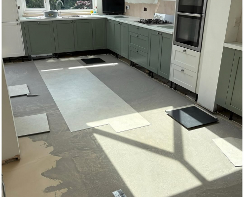 Surrey kitchen-diner kitchen area with light stone-effect LVT mid-installation