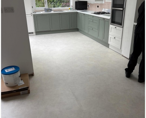 Surrey kitchen-diner kitchen area with finished light stone LVT flooring