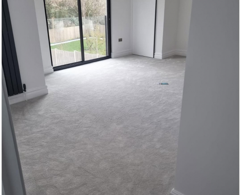 Bright Reigate bedroom with soft, light grey carpet installed