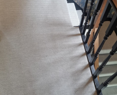 Alternate angle of Surrey stairs and landing with flatweave herringbone carpet