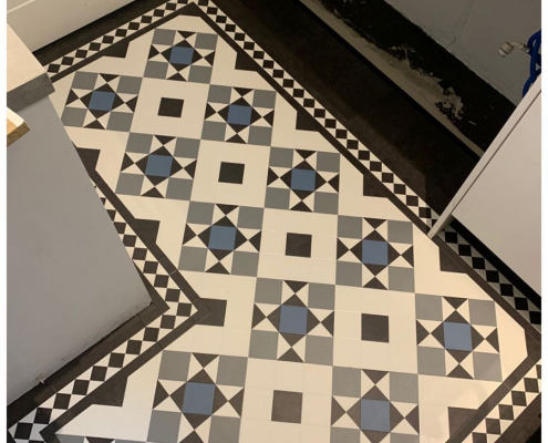 Redhill kitchen with bespoke heritage traditional tile LVT flooring in black, white, grey, and blue tiles