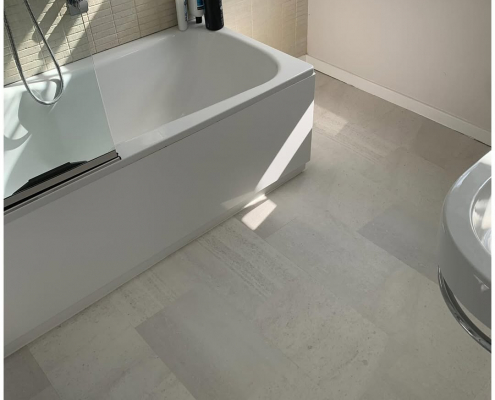 Surrey bathroom with light grey stone-effect LVT flooring installed, third view