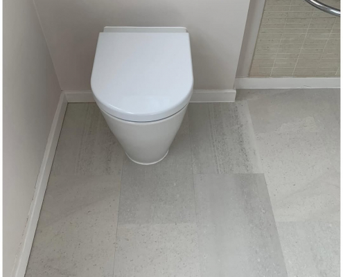 Surrey bathroom with light grey stone-effect LVT flooring installed, second view