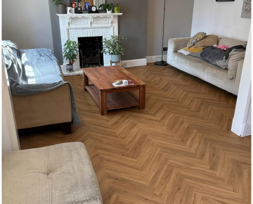Surrey living room with finished warm oak herringbone LVT flooring installed
