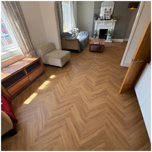 Bright Surrey living room with warm oak herringbone LVT flooring installed