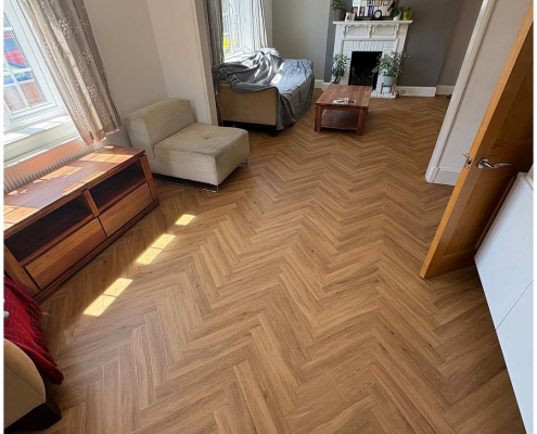 Bright Surrey living room with warm oak herringbone LVT flooring installed