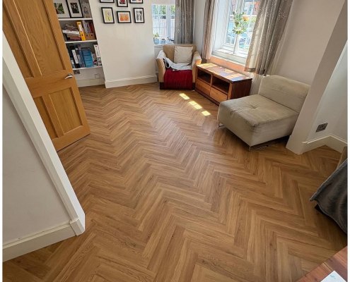 Surrey living room with oak herringbone LVT flooring installed