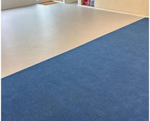 School classroom with ribbed blue carpet and light grey safety flooring installed