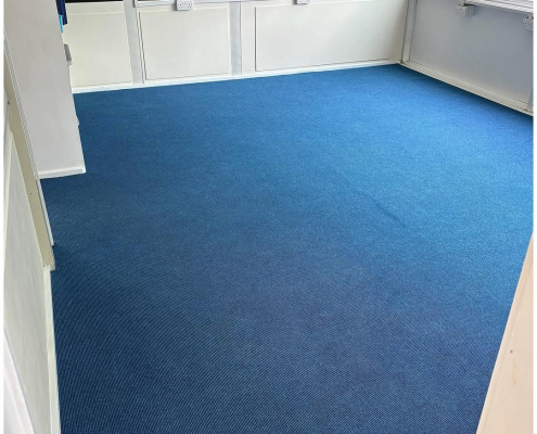 School classroom with commercial grade blue ribbed carpet