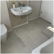 Surrey bathroom with light grey stone-effect LVT flooring installed, first view