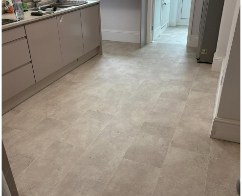 Stone effect cushion vinyl kitchen flooring installation London kitchen with warm grey stone tile-style cushion vinyl flooring installed